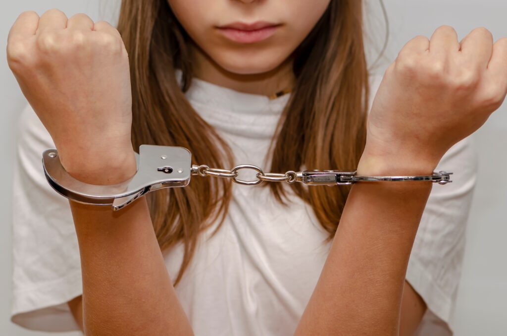 young girl in handcuffs