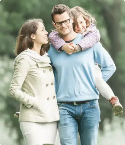 Woman looking at her husband carrying their daughter