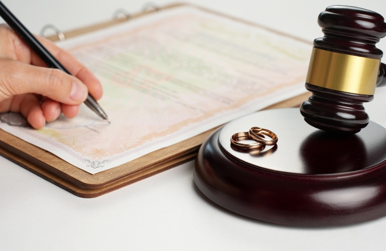 man signs divorce papers