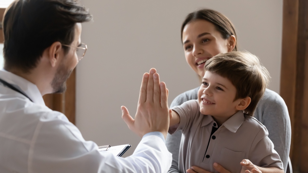 Happy little boy kid sitting on mommy's lap