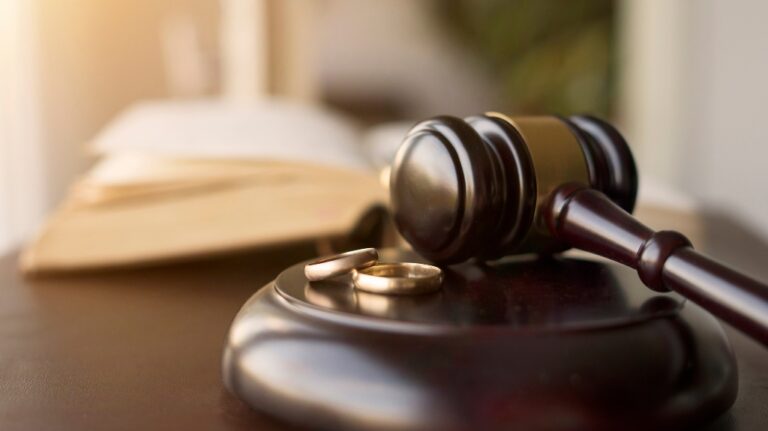 Judge gavel and wedding rings for divorce proceeding