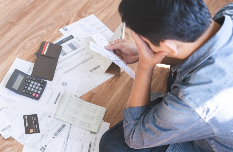 man calculates expense from invoice credit card bill