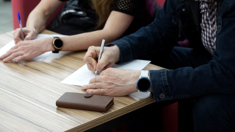 Adult man and woman fill out the forms for divorce