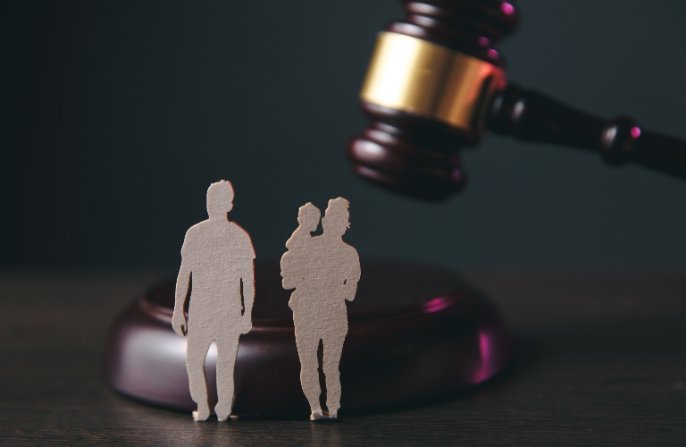 Family figures and gavel on the table